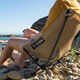 The Helinox Chair Zero weighs less than a pound, packs up to the size of a water bottle, but is actually a proper chair with ground clearance.